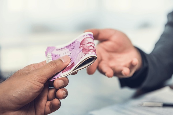 businessman-giving-money-indian-rupee-600nw-699885439